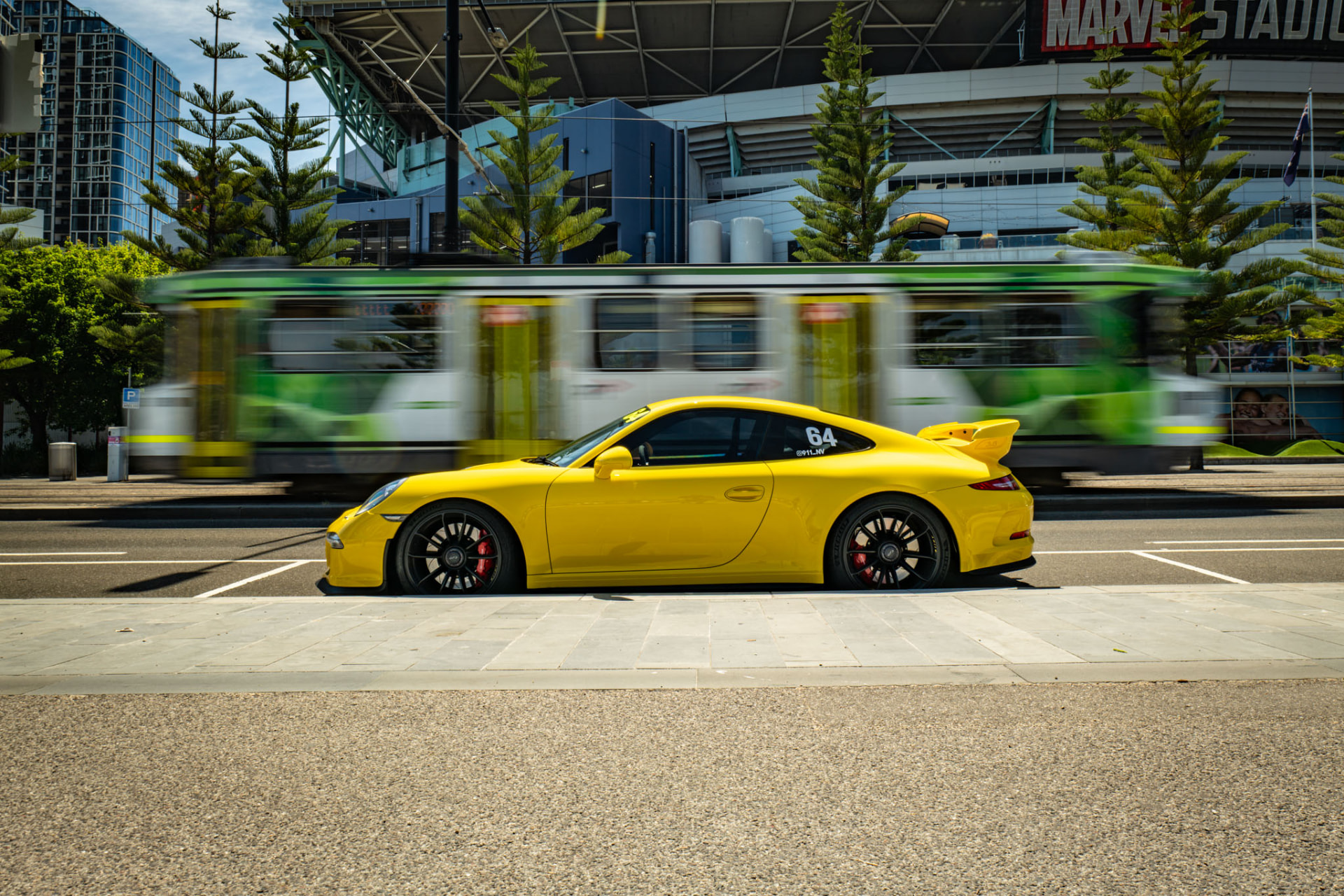 Yellow sports car captured in motion through the city