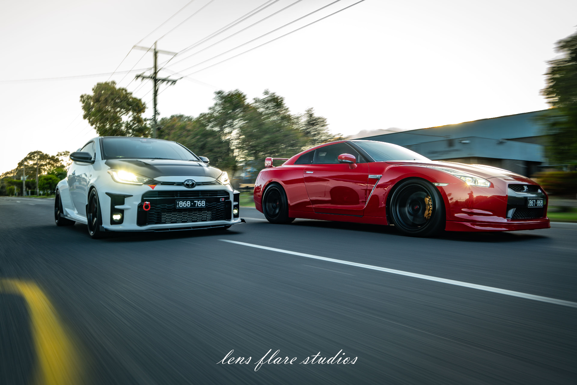 Red and silver sports cars photographed together on the road
