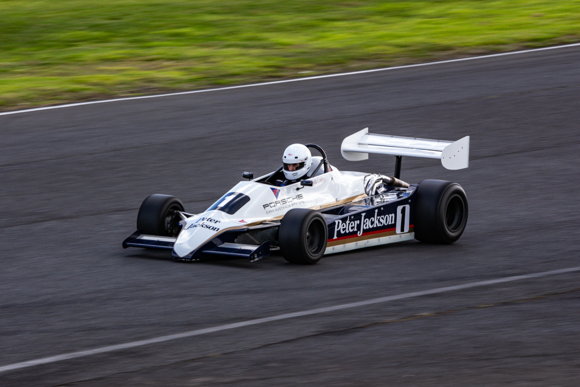 White open-wheel race car on the circuit